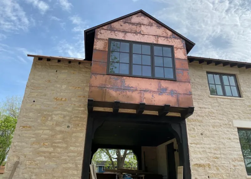 Copper metal panel facade on a stone building for Roof Repair in Haysville