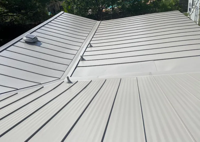 Solar attic fan installed on a metal roof for Roof Ventilation in Haysville